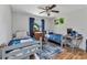 Cozy bedroom featuring two twin beds, ceiling fan, hardwood floors, and playful decor creating an inviting space at 5404 Carso Ter, North Port, FL 34286