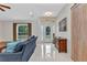 Bright foyer with tiled floors, front door, and natural light at 5404 Carso Ter, North Port, FL 34286