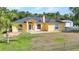 Inviting single-Gathering home featuring a well-manicured lawn and charming front entrance at 5404 Carso Ter, North Port, FL 34286
