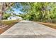 A large concrete pad in the backyard leads to a Quonset hut style garage at 5404 Carso Ter, North Port, FL 34286