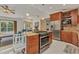 Open-concept design featuring a kitchen island with a gas range and modern appliances at 5404 Carso Ter, North Port, FL 34286