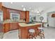 Well-equipped kitchen with center island, stone countertops, and backsplash at 5404 Carso Ter, North Port, FL 34286