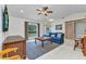 Cozy living room with a ceiling fan, comfortable seating, and view of the front entryway at 5404 Carso Ter, North Port, FL 34286
