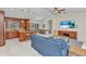 Open-concept living space with kitchen island, dining area, and entertainment center at 5404 Carso Ter, North Port, FL 34286