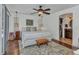 Serene bedroom with a ceiling fan, hardwood floors, with a walk in closet and ensuite bathroom at 5404 Carso Ter, North Port, FL 34286