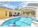 The screened in pool with outdoor seating offers a relaxing backyard experience at 5404 Carso Ter, North Port, FL 34286