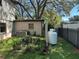Backyard area with lush greenery, a small shed, and a fenced perimeter at 8641 May Cir, Tampa, FL 33614