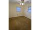 Bedroom with carpeted floors, simple lighting, and natural light from two windows at 8641 May Cir, Tampa, FL 33614