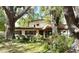 Charming two-story home with a well-manicured front yard and mature trees offering shade at 8641 May Cir, Tampa, FL 33614