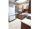 Functional kitchen featuring wooden cabinets, essential appliances, and durable tile flooring at 8641 May Cir, Tampa, FL 33614