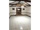 Spacious living room with a fireplace, tile flooring, and wood-beam ceiling at 8641 May Cir, Tampa, FL 33614