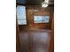 Room with wood paneling, tile floors and natural light at 8641 May Cir, Tampa, FL 33614