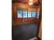 Room featuring wood paneling, bay window and carpeted flooring at 8641 May Cir, Tampa, FL 33614