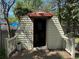 Shed with a covered porch, offering additional outdoor storage and workspace at 8641 May Cir, Tampa, FL 33614