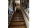 Staircase with wood steps and white walls adorned with decorations at 8641 May Cir, Tampa, FL 33614