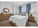 Bright bedroom with hardwood floors, a large window with blue curtains and decorative accents at 1238 E Kennedy Blvd # 802, Tampa, FL 33602
