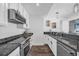 Stylish kitchen with stainless dishwasher and sink, and dark-granite countertop at 1238 E Kennedy Blvd # 802, Tampa, FL 33602