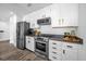 Modern condo kitchen with stainless steel appliances, granite countertops and white cabinets at 1238 E Kennedy Blvd # 802, Tampa, FL 33602