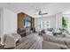 Bright living room with wood floors, modern furniture, large windows and a stone accent wall with a large screen TV at 1238 E Kennedy Blvd # 802, Tampa, FL 33602