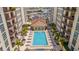 Aerial view of community pool surrounded by lounge chairs and palm trees within a residential building at 1238 E Kennedy Blvd # 802, Tampa, FL 33602