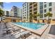 Community pool with multiple lounge chairs surrounding the pool area outside the residential building at 1238 E Kennedy Blvd # 802, Tampa, FL 33602