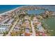 Coastal neighborhood with colorful beach houses, a sandy beach, and a tranquil waterway at 15406 2Nd E St, Madeira Beach, FL 33708