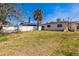 Spacious backyard with a privacy fence, lush lawn and mature trees, perfect for outdoor activities at 15406 2Nd E St, Madeira Beach, FL 33708