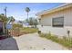 Backyard showcasing a concrete patio, well-maintained lawn, and privacy fence with mature landscaping at 15406 2Nd E St, Madeira Beach, FL 33708