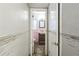 View into outdated bathroom features pink tiling, vanity, and decor at 15406 2Nd E St, Madeira Beach, FL 33708