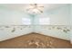 Bedroom needing remodel, featuring neutral walls, a ceiling fan, and natural light from window at 15406 2Nd E St, Madeira Beach, FL 33708