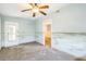Bedroom with ceiling fan, light blue walls and connecting door at 15406 2Nd E St, Madeira Beach, FL 33708
