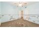 Bedroom needing remodel, with neutral walls, a ceiling fan, and closet door at 15406 2Nd E St, Madeira Beach, FL 33708