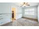 Empty bedroom with light walls, ceiling fan and tiled floor at 15406 2Nd E St, Madeira Beach, FL 33708