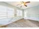 Bedroom with ceiling fan, large window, and tiled floor at 15406 2Nd E St, Madeira Beach, FL 33708