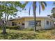 View of the front exterior of a well-maintained home with mature trees, offering shade and character to the property at 15406 2Nd E St, Madeira Beach, FL 33708