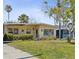 Lovely single-story home with a well-kept lawn, offering a classic and inviting front exterior, complemented by mature landscaping at 15406 2Nd E St, Madeira Beach, FL 33708
