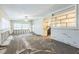 Spacious living room with tile floors, ceiling fan, and wall cutout to the kitchen at 15406 2Nd E St, Madeira Beach, FL 33708