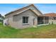 Exterior view of the home showcasing the well-maintained backyard and screened-in porch at 29704 Eagle Station Dr, Wesley Chapel, FL 33543