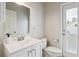 Bright bathroom featuring a white vanity with a solid surface top and a walkout door at 29704 Eagle Station Dr, Wesley Chapel, FL 33543