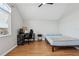 Simple bedroom with wood floors offering space for a bed and workspace at 29704 Eagle Station Dr, Wesley Chapel, FL 33543