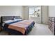Cozy bedroom with a large window, providing ample natural light, and carpet flooring at 29704 Eagle Station Dr, Wesley Chapel, FL 33543