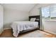 Cozy bedroom with wood floors, a comfortable bed, and natural light from the window at 29704 Eagle Station Dr, Wesley Chapel, FL 33543