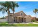 Charming single-Gathering home featuring a well-manicured lawn and mature palm trees at 29704 Eagle Station Dr, Wesley Chapel, FL 33543
