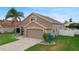 Lovely home features a two-car garage, lush lawn, and mature landscaping at 29704 Eagle Station Dr, Wesley Chapel, FL 33543