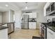 Modern kitchen features stainless steel appliances, granite countertops, and wood-look flooring at 29704 Eagle Station Dr, Wesley Chapel, FL 33543