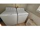 Well-equipped laundry room with modern washer and dryer units and storage at 29704 Eagle Station Dr, Wesley Chapel, FL 33543