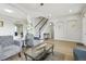 Bright and airy living room with hardwood floors and staircase leading to upper level at 29704 Eagle Station Dr, Wesley Chapel, FL 33543