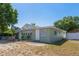 The backyard features green siding, a bright white door, windows with white trim, and minimal landscaping at 4100 46Th N Ave, St Petersburg, FL 33714