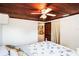 Cozy bedroom with wood ceiling, bed, ceiling fan, and door to another room at 4100 46Th N Ave, St Petersburg, FL 33714