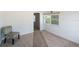 Bright bedroom featuring neutral carpeting, white walls, and a patterned accent chair near a sunlit window at 4100 46Th N Ave, St Petersburg, FL 33714
